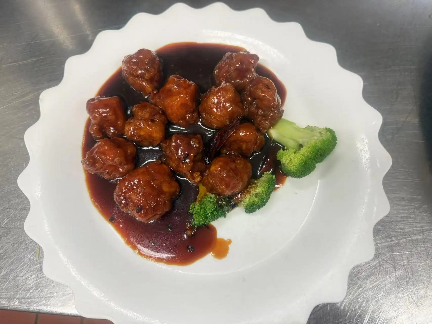 General-Tso’s-Chicken presents breaded and fried chicken pieces in a rich sauce at China Panda, a Asian restaurant in Athens